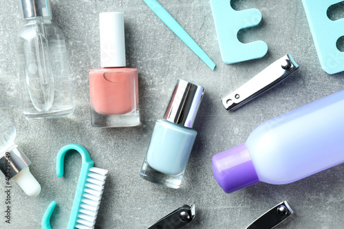 Concept of nail care with manicure accessories on gray textured background