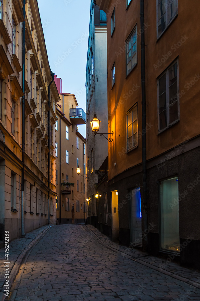 Perspective view of historical buildings on the Tyska Skolgrand Alley at twilight, Stockholm, Sweden
