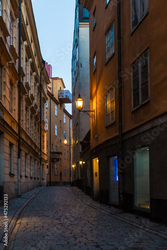 Perspective view of historical buildings on the Tyska Skolgrand Alley at twilight, Stockholm, Sweden 