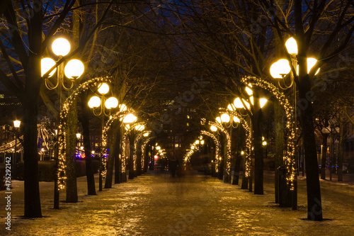 Beautiful perspective view of the illuminated Birgit Nilsson Alley in the Kungstradgarden Park at dusk, Stockholm, Sweden
 photo