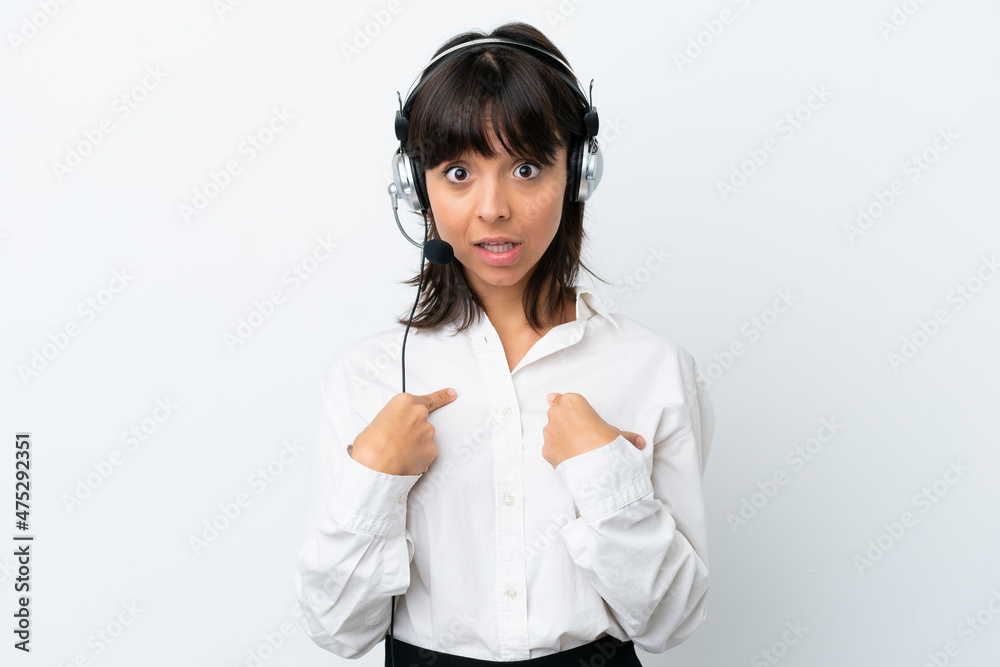 Telemarketer mixed race woman working with a headset isolated on white background with surprise facial expression Telemarketer mixed race woman working with a headset isolated on white background with surprise facial expression