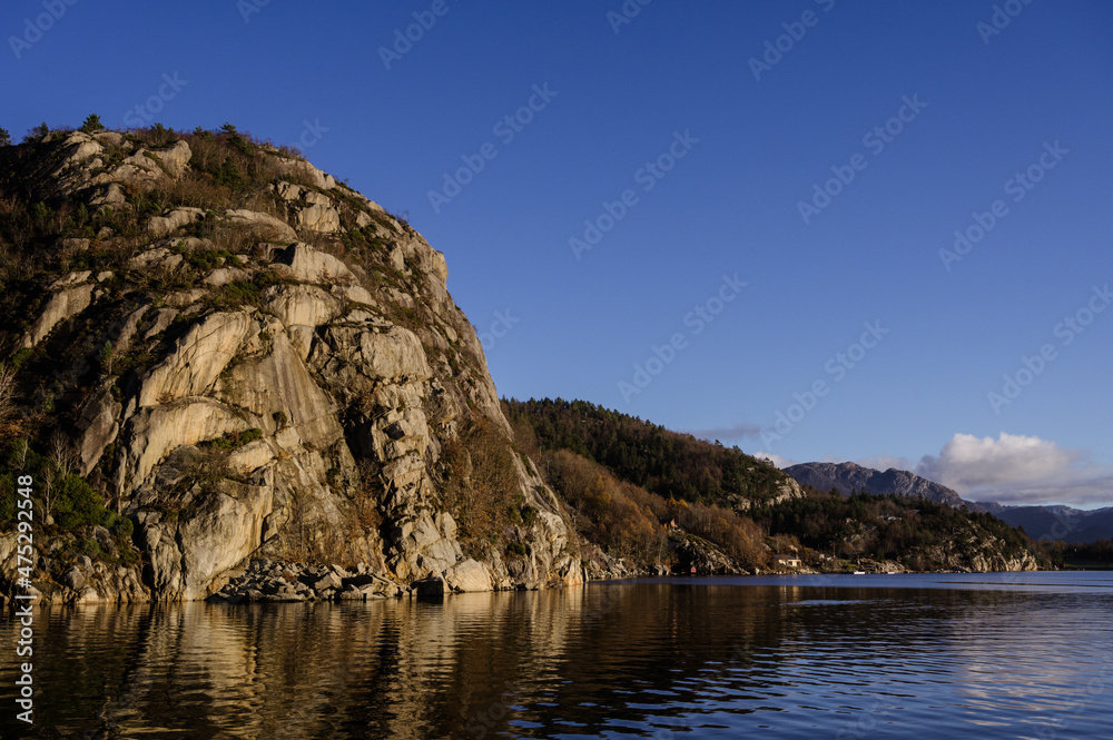 Landscape of trees on rocky islands in Lusefjord. Fjord cruise. Tourism in Norway. Beautiful nature at sunny day.