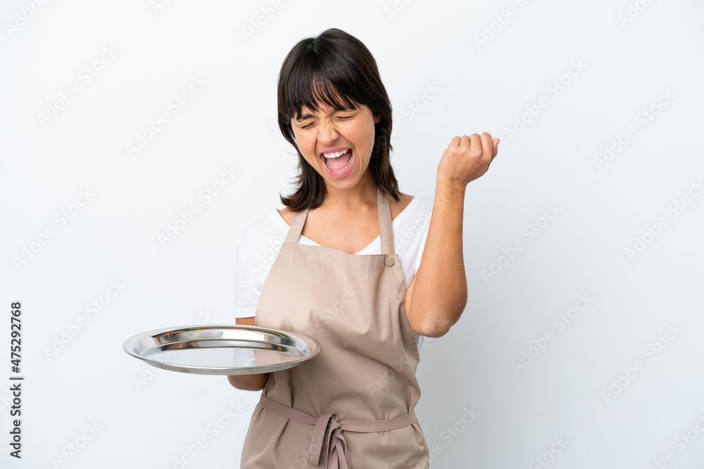 Young waitress with tray isolated on white background celebrating a victory Young waitress with tray isolated on white background celebrating a victory