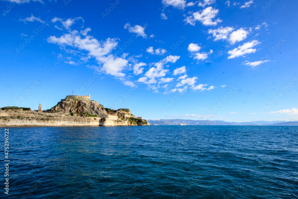 	
Corfu Castle old fort Greek island surrounded by blue sea sky and mountains a tourist attraction in Mediterranean Greece.	
