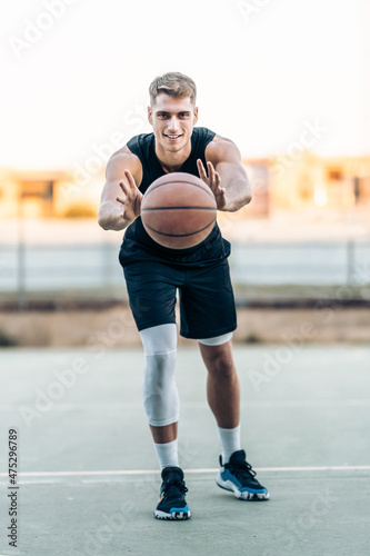 Basketball player passing the ball outdoors