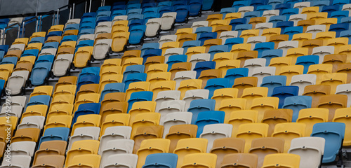 empty colorful seats on tribunes of stadium photo