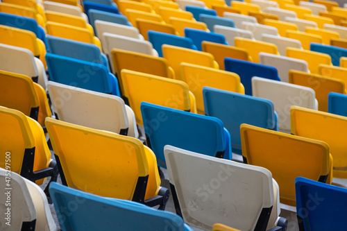 empty colorful seats on tribunes of stadium