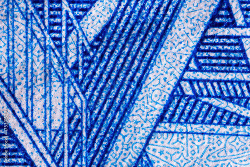 Abstract decorative money background. Fragment of a banknote. Engraving and pattern. The two thousandth Russian banknote. Ultra macro photography.
