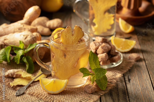 Ginger tea with ingredients on an old wooden table.