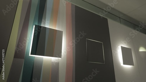 Overview of a colorful wall with some minimal and design lighting.