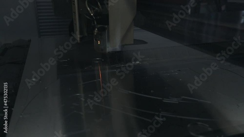 Closeup of a laser machine cutting metal component.
Factory production machine.