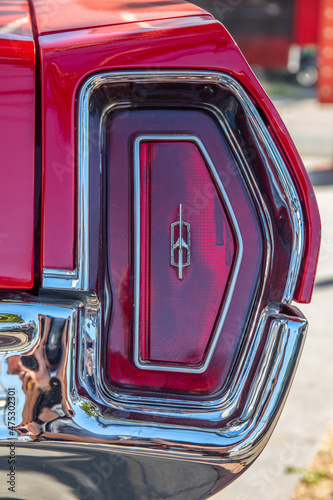 The red brake light or taillight of a red classic car or Muscle- Car