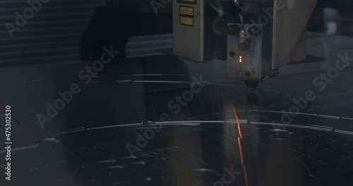 Closeup of a laser machine cutting metal component.
Factory production machine.