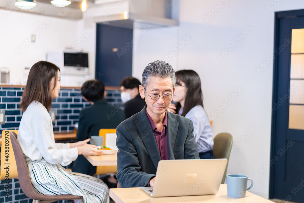カフェで仕事をする中年男性 カフェで仕事をする中年男性