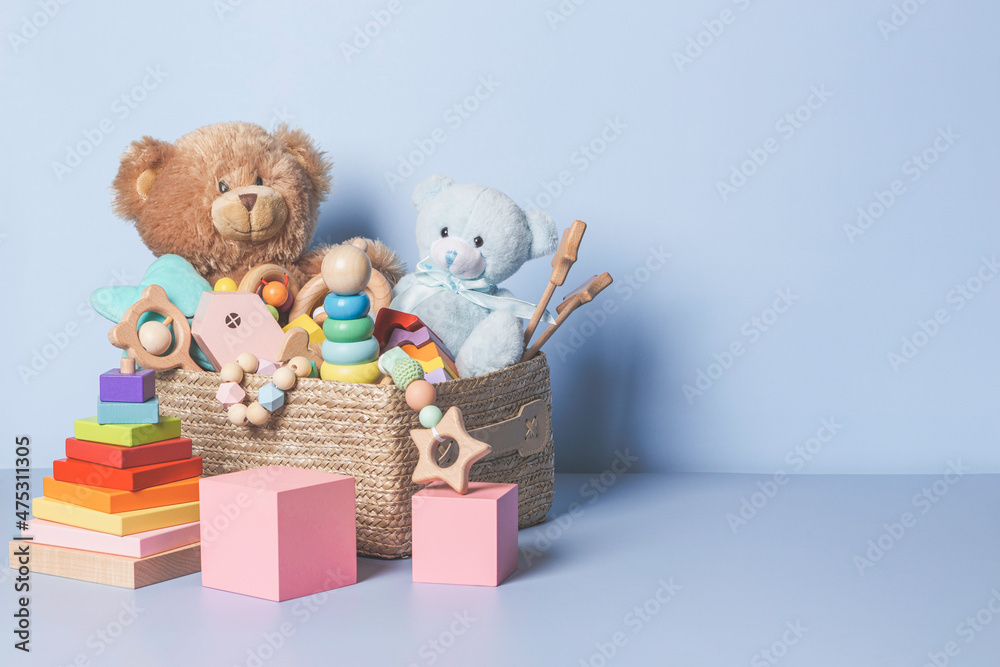 Toy box full of baby kid toys. Container with teddy bear, wooden