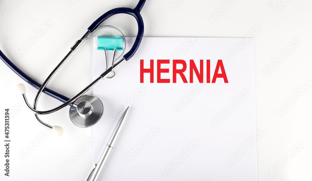 HERNIA text written on paper with a stethoscope. Medical concept. HERNIA text written on paper with a stethoscope. Medical concept.