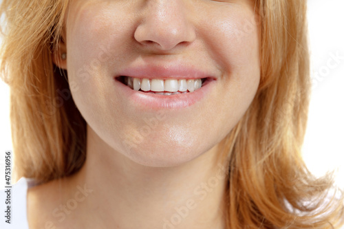 Close-up of open smiling female mouth without lips makeup. Cosmetology, medicine, dental health. Detailed.
