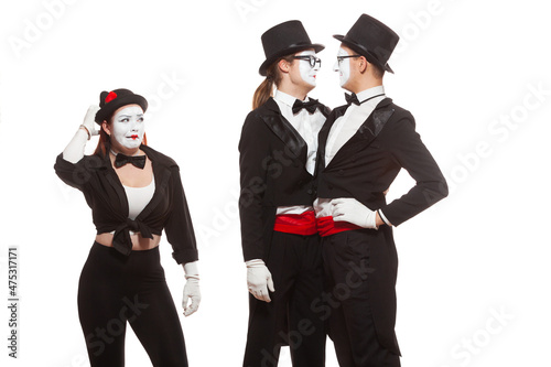 Portrait of three mime artists performing, isolated on white background. Two men embrace, and the girl is perplexed. Symbol of tolerance, same-sex marriage, the LGBT community