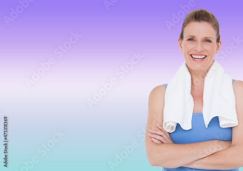 Portrait of caucasian woman with towel around her neck smiling against purple gradient background