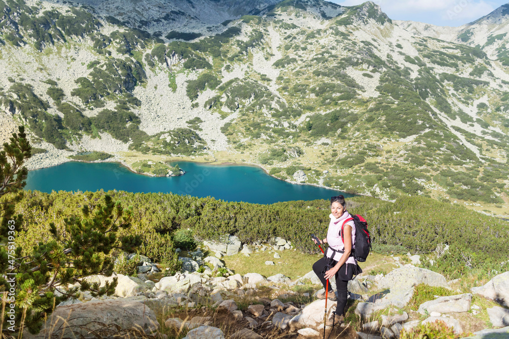 Hiker Woman in the High Mountain with Lake View . Pirin mountain ,Bulgaria 