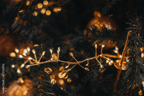 Golden magic glittering bokeh lights of Christmas festive garland. New Year festive background