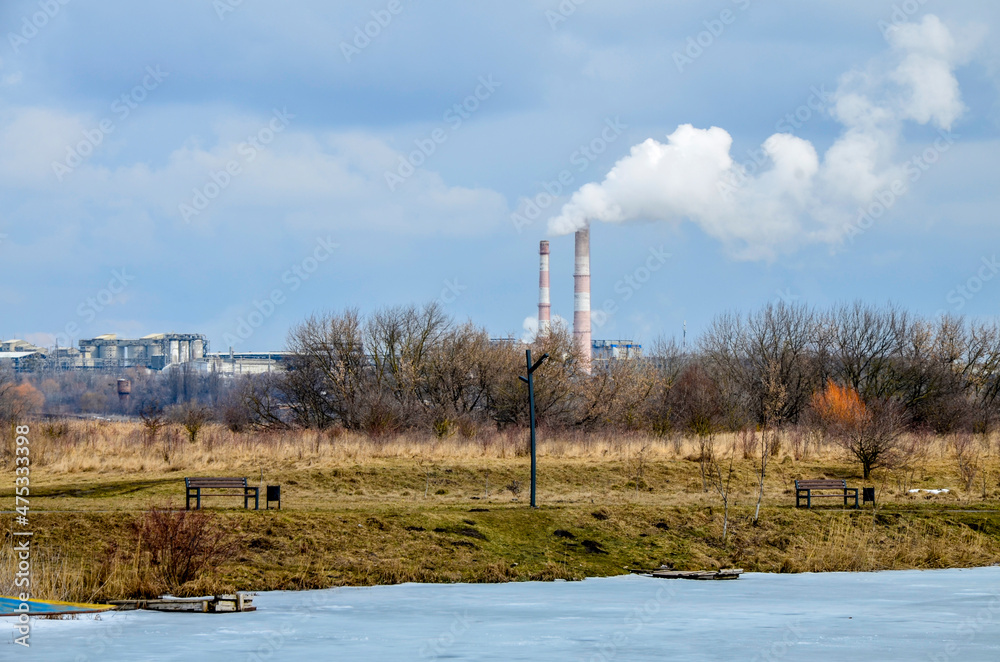 pipes of the cement plant against the background of the landscape and sky. pipes of the cement plant against the background of the landscape and sky.
