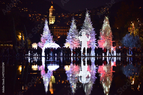 Christmas decorations with snow-covered trees and funfair Ferris wheel. Nice, France