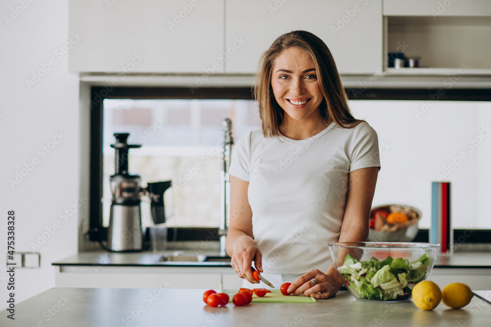 Young woman making salad at the kitchen Young woman making salad at the kitchen
