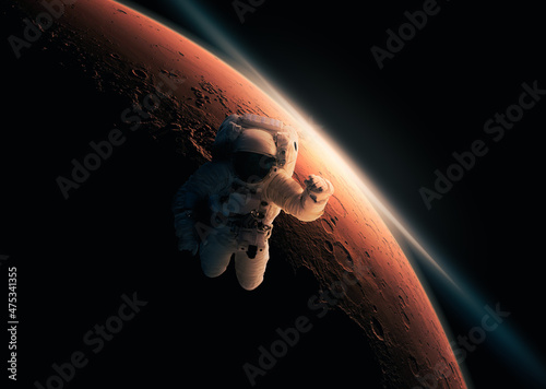 Fototapeta Naklejka Na Ścianę i Meble -  Astronaut or cosmonaut on spacewalk with planet mars in the background. Space expolarion, travel and science of stars. Elements in the image furnished by NASA.