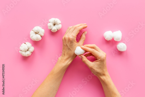 Cotton wool balls in female hands - clean and care for skin
