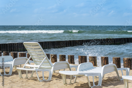 A row of sun loungers on the beach. © YuNIK