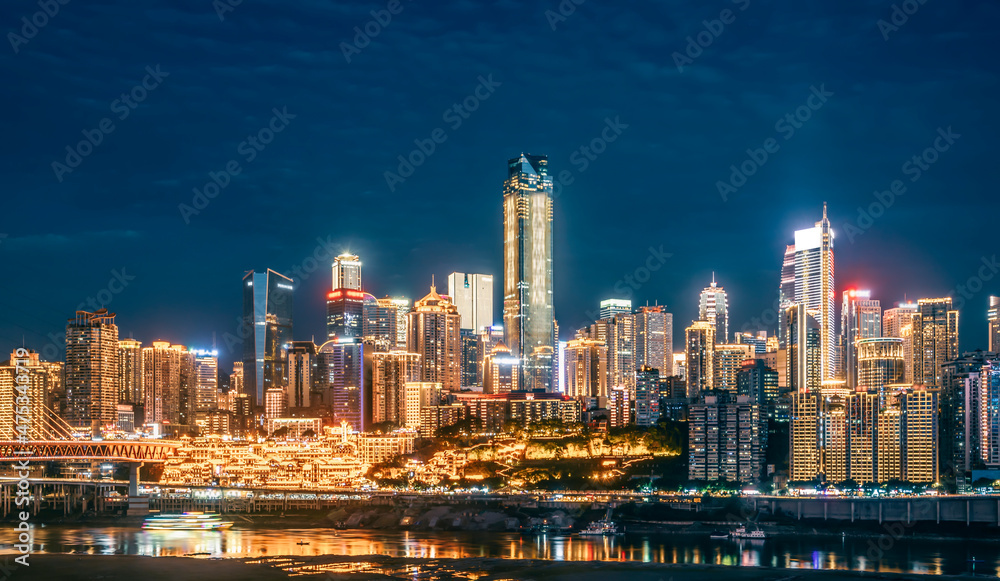 cityscape and skyline of downtown near water of chongqing at night