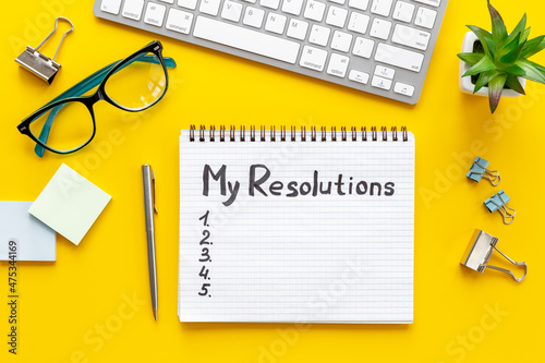 New Year resolution hand writing list - text on notepad, top view