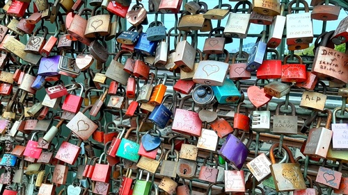 Love locks hanging on a metal bridge © a_elmo