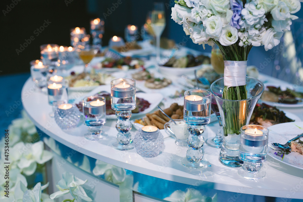 Served wedding banquet table with dishes in the restaurant Served wedding banquet table with dishes in the restaurant