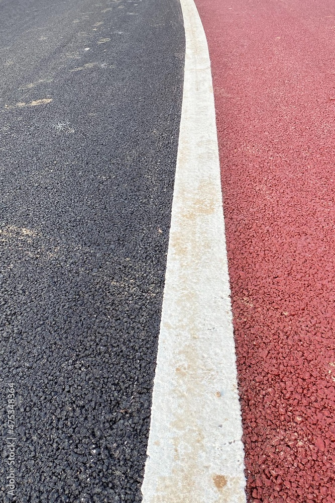 Fototapeta premium Vertical pattern of a asphalt road background