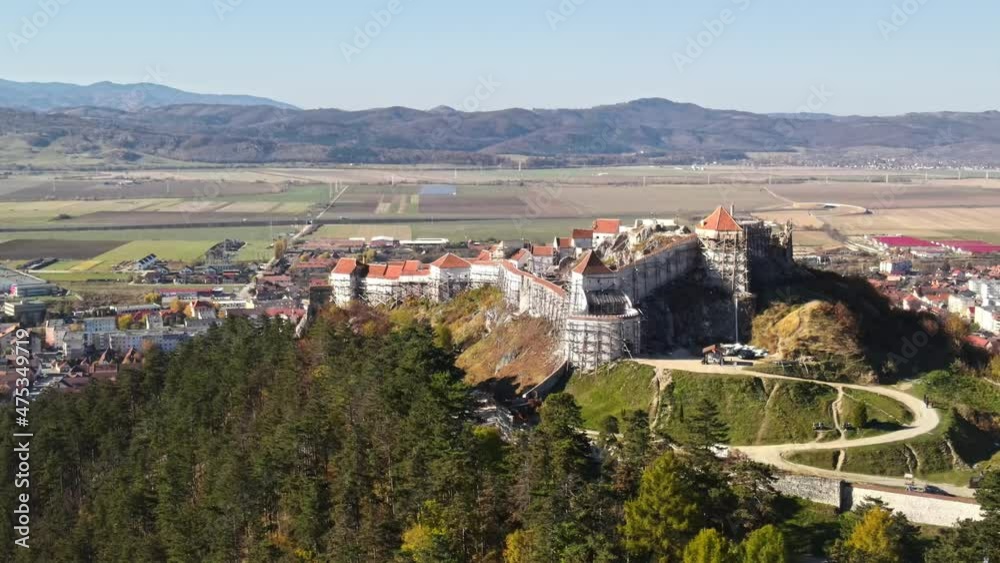 Aerial drone view of The Rasnov Fortress in Romania. Medieval fortress on the top of the hill, village near it Aerial drone view of The Rasnov Fortress in Romania. Medieval fortress on the top of the hill, village near it