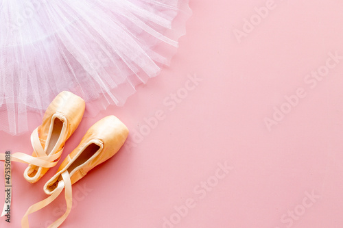 White ballet tutu skirt and beige pointe shoes with ribbon