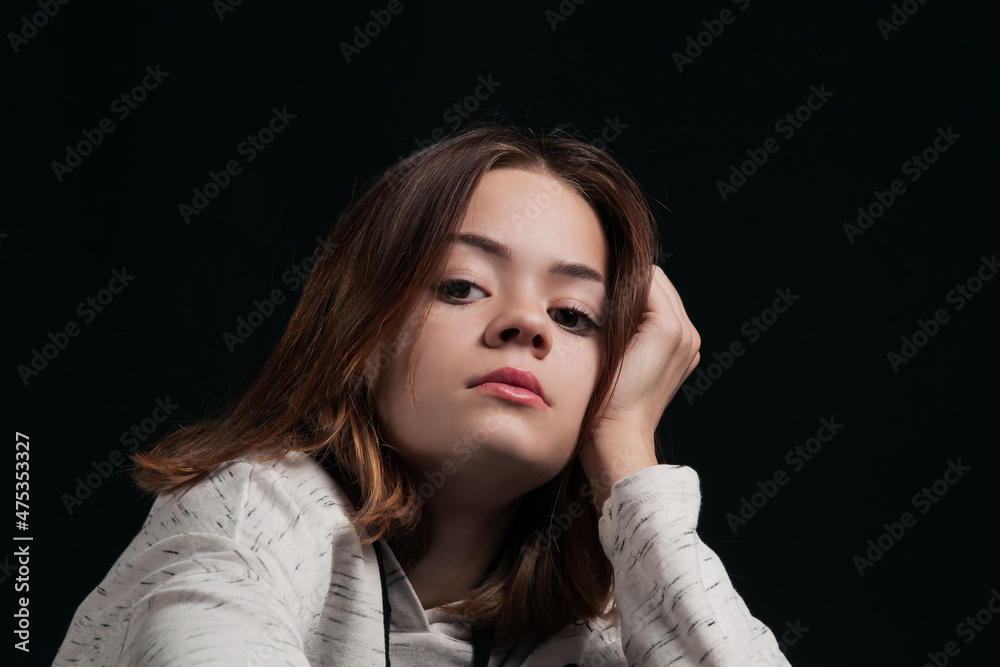 A young girl on a dark background A young girl on a dark background