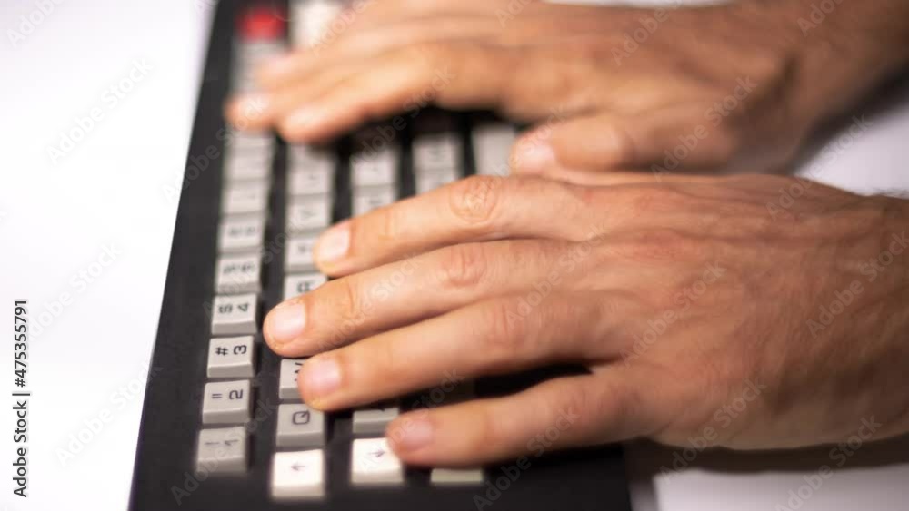 Hands typing on computer keyboard