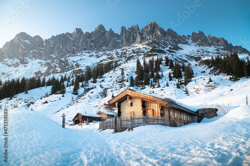 Obraz na płótnie Winter mountain landscape in the Alps with traditional mountain huts w salonie