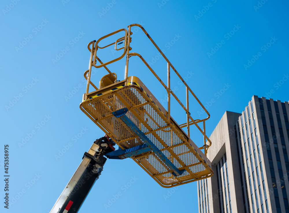 bucket of cherry picker against blue sky bucket of cherry picker against blue sky