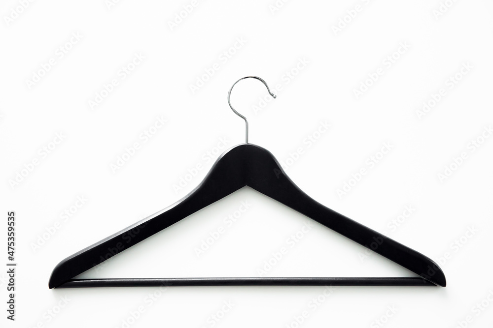 Black wooden hanger isolated on white background. Shopping and sale concept. Copy space. Black wooden hanger isolated on white background. Shopping and sale concept. Copy space.