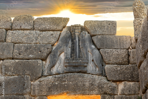 Canvas Print The sun sets behind the ancient Lion Gate entrance to the  archaeological site of Mycenae, a Greek Bronze Age citadel