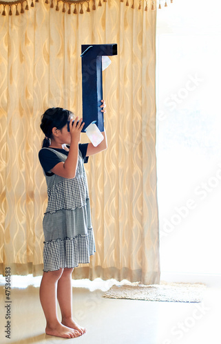 A girl looking through her DIY periscope photo