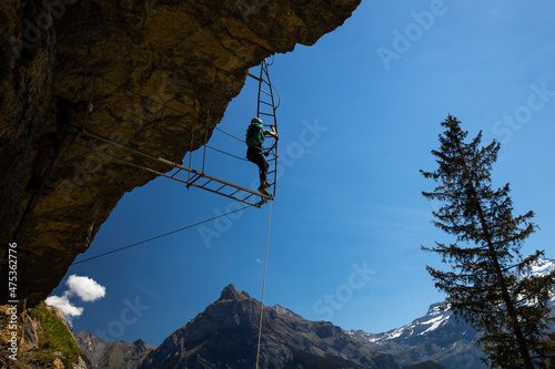 Young people on a via ferrata route in Swiss Alps photo