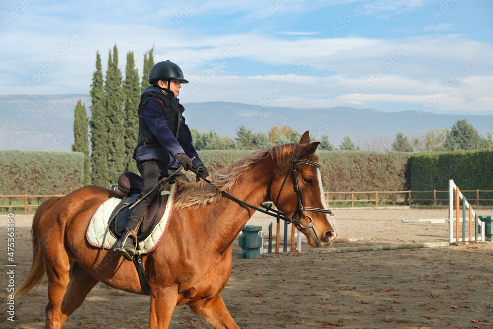 Kid riding horse at the ranch with obstacles and barriers. Kid riding horse at the ranch with obstacles and barriers.