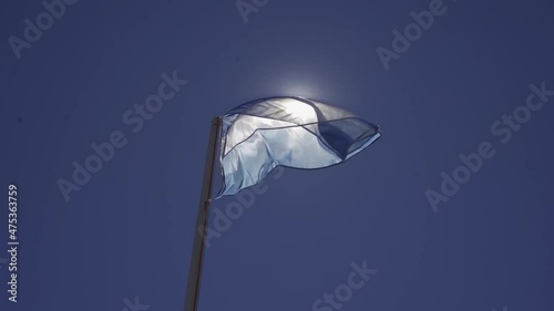 bandera argentina flameando sobre el sol photo