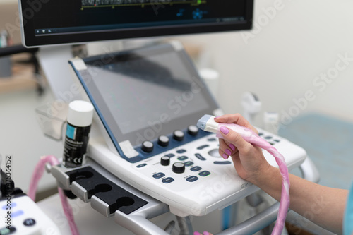 Doctor with professional equipment. Ultrasound scanner in doctor`s hands. Diagnostics. Sonography concept