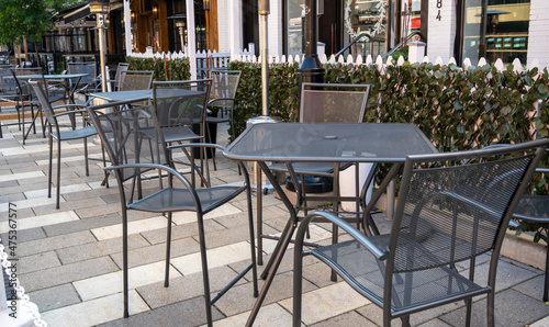 tables with chairs in a street cafe © Yuri